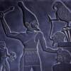 Hieroglyphics carved into black stone.